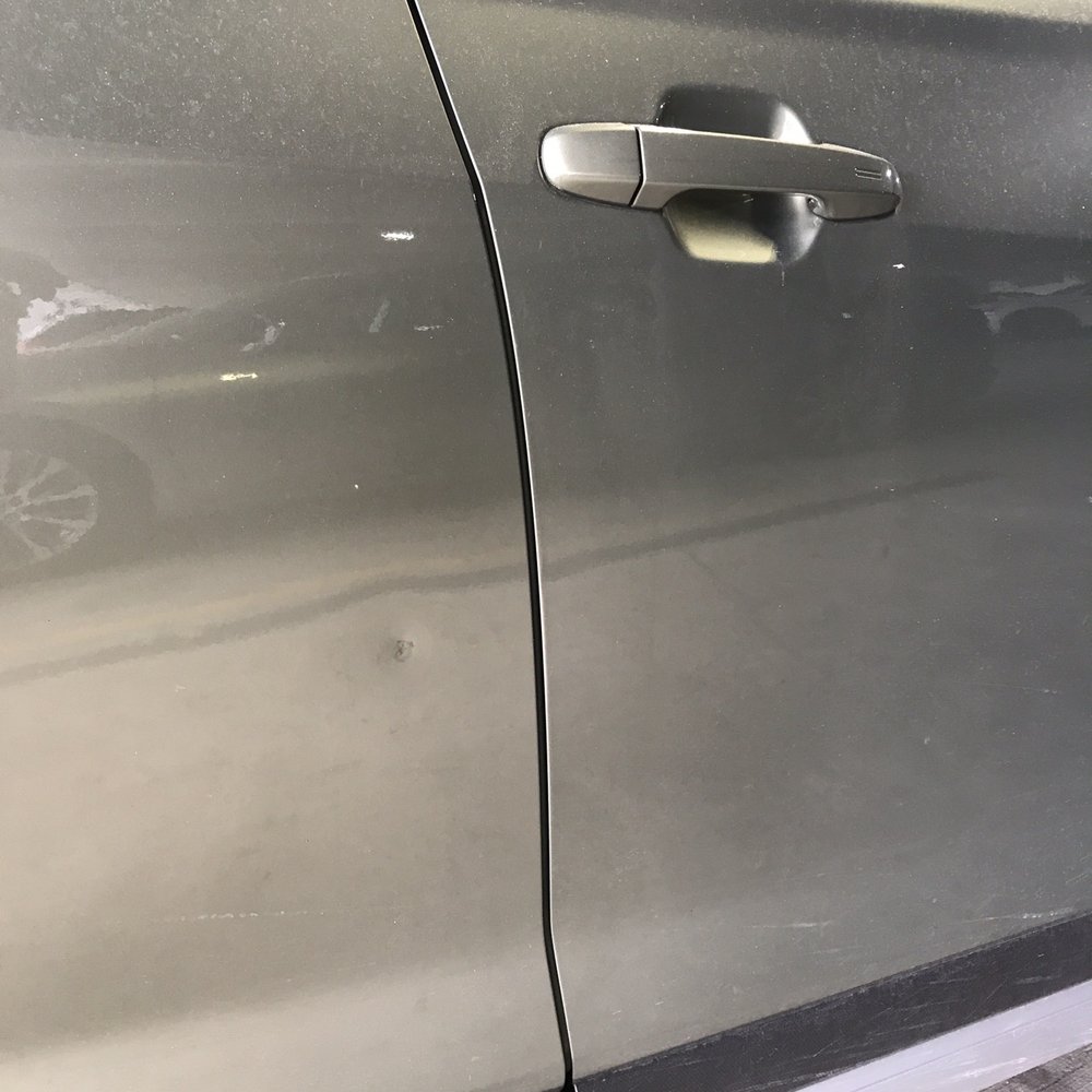 Before the fix - a nickel to quarter sized dent and marks visible. Before the fix - a nickel to quarter sized dent and marks visible.