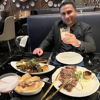 Prime 141 - Pictured: 20oz Black Angus Ribeye Steak sliced to share, twice purée and the Brussel sprouts. Cocktail drinks libra and Scorpio. - Steakhouses Near Me - Enterprise, Nevada Prime 141 - Pictured: 20oz Black Angus Ribeye Steak sliced to share, twice purée and the Brussel sprouts. Cocktail drinks libra and Scorpio. - Steakhouses Near Me - Enterprise, Nevada