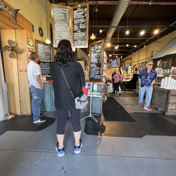 Penn Ave Fish Company - a woman standing at the counter - Sushi Bars Near Me - Pittsburgh, Pennsylvania
