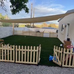Trillanes Landscaping - Beautiful artificial turf installation with shade sail, fence, and fireplace.Year round outdoor living.