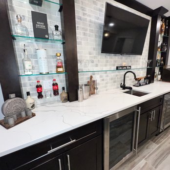 Clean Edge Construction - a kitchen counter with a tv mounted above it - General Contractors Near Me Clean Edge Construction - a kitchen counter with a tv mounted above it - General Contractors Near Me