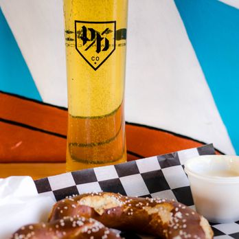 Prost Brewing - a plate of pretzels and a glass of beer - Breweries Near Me - Denver, Colorado