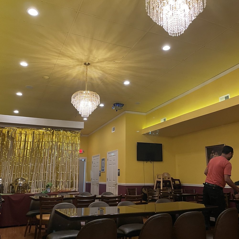 a man standing in the middle of a dining room a man standing in the middle of a dining room