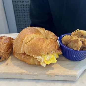 Café Miriam- City Park - Bacon, Egg and Cheese croissant sandwich with potatoes and a mini pain au chocolat - Coffee & Tea Near Me - Denver, Colorado