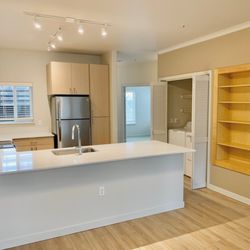 Wilsonville Summit Apartments - A kitchen with a white countertop and wooden flooring