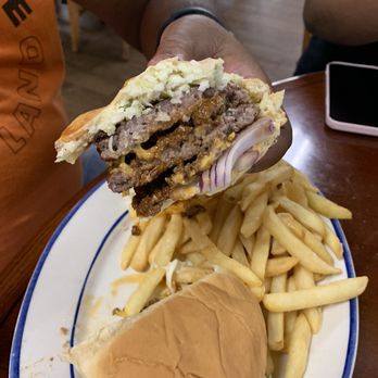 Stephanie's Restaurant - Inside of the Carolina burger with chili between the Pattie's and coleslaw on the burger with fries. - American Near Me - Greensboro, North Carolina