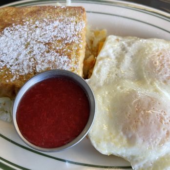 Breakfast Palace - Morning Monte Cristo: French toast layered with cheese, choice protein, two eggs any style, strawberry compote, and hash browns on the side. - Breakfast & Brunch Near Me - Denver, Colorado