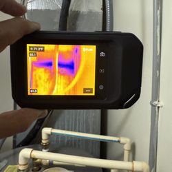 Apex Home & Property Inspections - Thermal camera shows moisture on the plenum of an AC unit