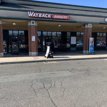 Wayback Burgers - a woman walking down the street - Burgers Near Me - Cheshire, Connecticut