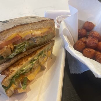 Grater Grilled Cheese - Chicken Pesto Grilled Cheese and Sweet Potato Tots Side - American Near Me - Irvine, California Grater Grilled Cheese - Chicken Pesto Grilled Cheese and Sweet Potato Tots Side - American Near Me - Irvine, California