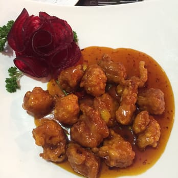 Hot Wok - Orange Chicken. Garnished with a radish rose - Chinese Near Me - Cypress, Texas