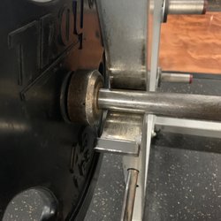 Anytime Fitness - This is the most clearance you can get between the weights on the bar and the rack.