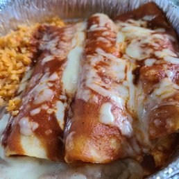 Shredded chicken enchiladas, rice, and refried beans. Shredded chicken enchiladas, rice, and refried beans.