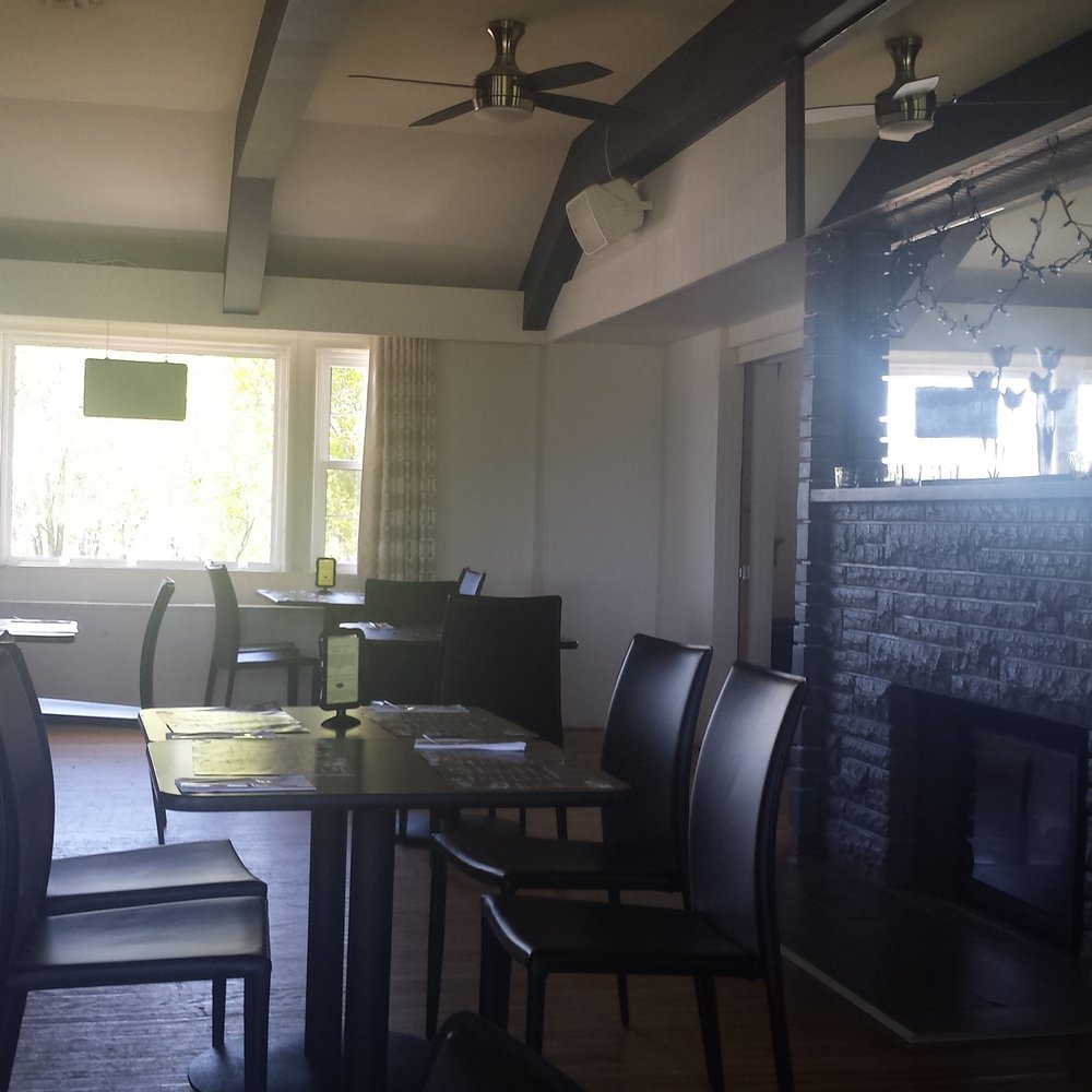 Flavor 19 - a dining room with a brick fireplace - Cocktail Bars Near Me - Sydney, Nova Scotia