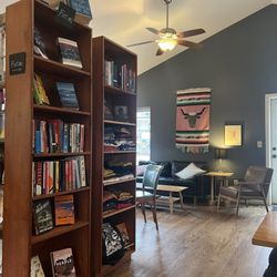 Daymoon Coffeebar - Books for sale, tables, a couch and comfy chair