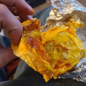 Five Guys - a person holding a piece of food - Burgers Near Me - Florence, Kentucky
