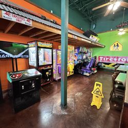 Tame room featuring and old style air hockey table in the far right (black and yellow stripes)