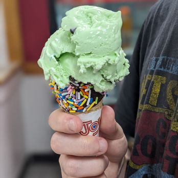 Carvel - a man holding a green ice cream cone with sprinkles - Ice Cream & Frozen Yogurt Near Me - Avon, Connecticut Carvel - a man holding a green ice cream cone with sprinkles - Ice Cream & Frozen Yogurt Near Me - Avon, Connecticut
