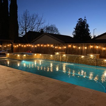 Cypress Builders - a backyard pool with lights - Landscaping Near Me