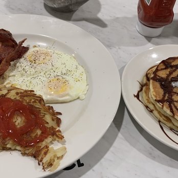 Village Inn - Chocolate chip pancakes, bacon, eggs and hash browns - Breakfast & Brunch Near Me - Fremont, Nebraska Village Inn - Chocolate chip pancakes, bacon, eggs and hash browns - Breakfast & Brunch Near Me - Fremont, Nebraska