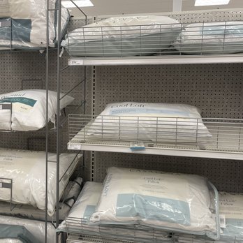 Target - Pillows - Multiple pillows are arranged on metal shelves in a retail store, with packaging labels visible. - Department Stores Near Me - El Paso, Texas