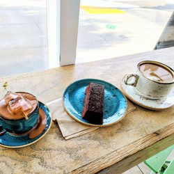 Craftsman and Wolves - The Den - Financier with hot chocolate with marshmallow and decaf latter with oat milk