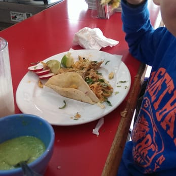 Pipo's Restaurant - a young boy eating a taco - Mexican Near Me - New York, New York Pipo's Restaurant - a young boy eating a taco - Mexican Near Me - New York, New York