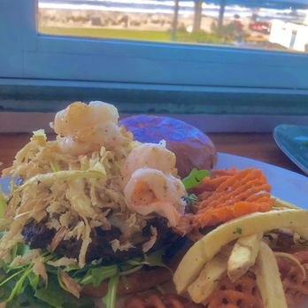 Wonderland Ocean Pub - Surf & Turf Burger has garlic prawns, beef patty, crispy leeks, arugula, lobster aioli on brioche bun + sweet potato fries - New American Near Me - San Diego, California Wonderland Ocean Pub - Surf & Turf Burger has garlic prawns, beef patty, crispy leeks, arugula, lobster aioli on brioche bun + sweet potato fries - New American Near Me - San Diego, California