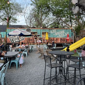 The Pigpen - a group of people sitting at tables outside - Bars Near Me - San Antonio, Texas The Pigpen - a group of people sitting at tables outside - Bars Near Me - San Antonio, Texas