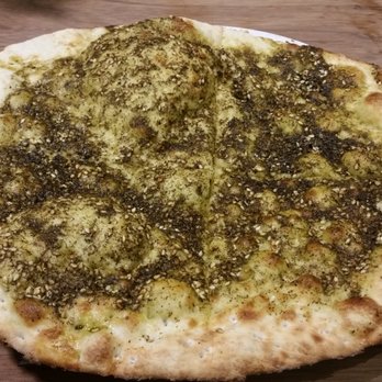 Paramount Fine Foods - a pizza on a wooden table - Middle Eastern Near Me - Burlington, Ontario Paramount Fine Foods - a pizza on a wooden table - Middle Eastern Near Me - Burlington, Ontario