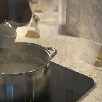 Sidney's - a person pouring milk into a pot - New American Near Me - Buford, Georgia
