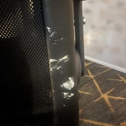 Desk chair with what looks to be toothpaste smeared on it.