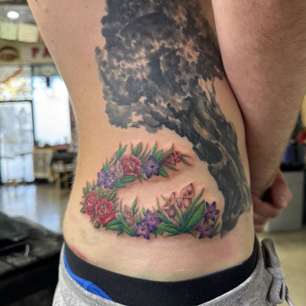 This tattoo is a remembrance of lost loved ones and Carlos helped me get beauty and life into my idea. This tattoo is a remembrance of lost loved ones and Carlos helped me get beauty and life into my idea.