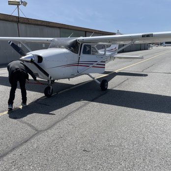 Fly Bay Area - Pilot towing plane - Flight Instruction Near Me - San Carlos, California Fly Bay Area - Pilot towing plane - Flight Instruction Near Me - San Carlos, California