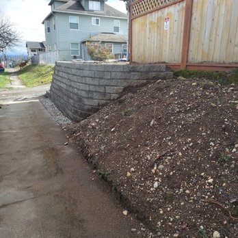 Sonrais General Contractor - a pile of dirt in front of a house - General Contractors Near Me