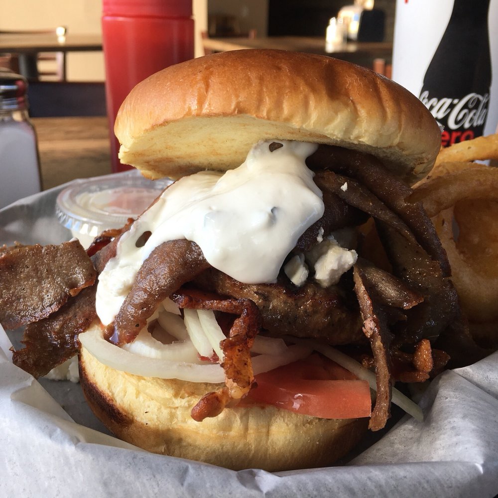 Kojak's - Greek freak burger. Burger with feta, gyros, tomato, onion, BACON, And tatziki sauce. Awesome combo! - American Near Me - Cary, Illinois Kojak's - Greek freak burger. Burger with feta, gyros, tomato, onion, BACON, And tatziki sauce. Awesome combo! - American Near Me - Cary, Illinois