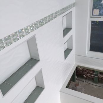 Prestige Installations - 12x36 Porcelain tiles with 4 niches and a glass border on shower and tub wall. - Flooring Near Me