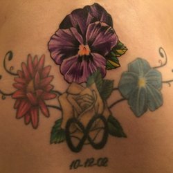Elysian Ink - Violet flower added to an older tattoo. Gorgeous!!