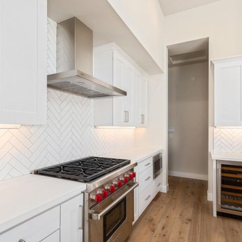 Victory Home Remodeling - a kitchen with white cabinets and stainless steel appliances - General Contractors Near Me - Los Angeles, California Victory Home Remodeling - a kitchen with white cabinets and stainless steel appliances - General Contractors Near Me - Los Angeles, California