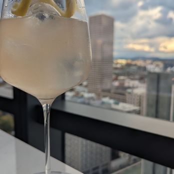 Bellpine - a glass of wine with a view of a city - Cocktail Bars Near Me - Portland, Oregon Bellpine - a glass of wine with a view of a city - Cocktail Bars Near Me - Portland, Oregon