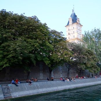 La Seine - Paris - Locals and tourists picnicking along the Seine River in Paris. - Landmarks & Historical Buildings Near Me