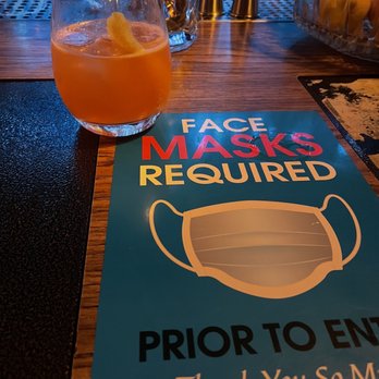 Dead Ringer Analog Bar - a drink and a mask sign - Bars Near Me - Reno, Nevada