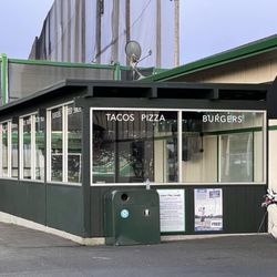 Mariners Point Golf Course & Driving Range - Birdie's Bar & Grill - exterior covered patio area with glass windows (for wind break). Half of the patio is uncovered with two fire pits.