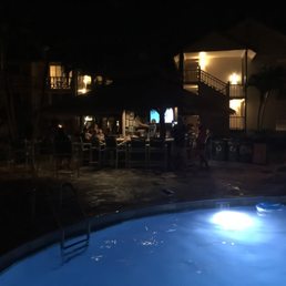 a pool at night with people in the background