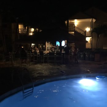 The Sandbar - a pool at night with people in the background - Lounges Near Me - Kapaa, Hawaii