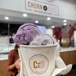 Exterior outside entrance of Churn And Bake Ice Cream - Side view of a triple scoop: ube coconut crunch, lavender honey, and black sesame on the bottom - Plano, Texas Exterior outside entrance of Churn And Bake Ice Cream - Side view of a triple scoop: ube coconut crunch, lavender honey, and black sesame on the bottom - Plano, Texas