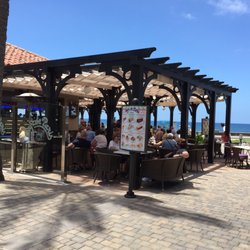 Cafe de Paris - Het terras met op de achtergrond de oceaan. Bezien vanaf het winkelcentrum.
