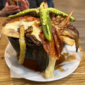 Muchacho Alegre - Molcajete beans and cheese marketed as mar y tierra. - Seafood Near Me - Aurora, Illinois Muchacho Alegre - Molcajete beans and cheese marketed as mar y tierra. - Seafood Near Me - Aurora, Illinois