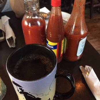 The Attic - Coffee in a Mary Poppins mug haha and 2 hot sauces and ketchup provided on each table - Breakfast & Brunch Near Me - Long Beach, California