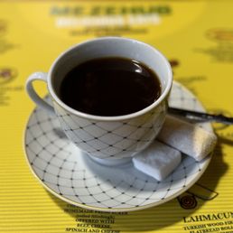 Turkish coffee with a sugar cube and tiny stirring spoon (plus a little treat!) .... Mmm!